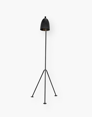 Industrial Steel Floor Lamp with a matte black finish on three pronged legs.