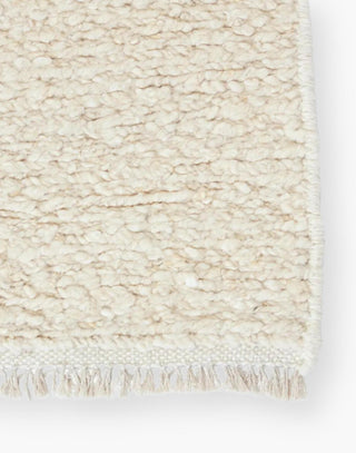 Wool rug with a light neutral cream palette and soft, textural soumak weave details.