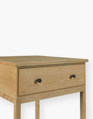 Table with a square oak top resting over a storage drawer with legs joined by a low shelf.