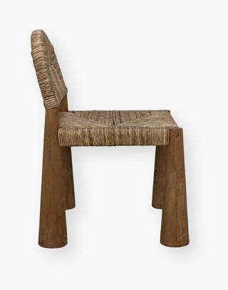 A stunning dining room chair with natural teak paired with seagrass.