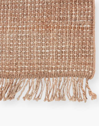 Jute rug with a texture-rich chunky weave, with a casually elegant layer lends an earthy accent in a duo-toned ivory and beige colorway with a knotted fringe.
