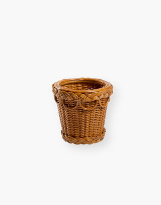 Small handwoven and braided rattan pot for gardening or indoor use.