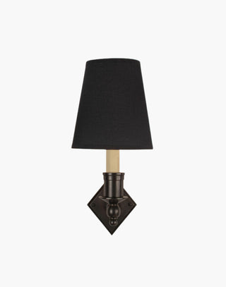 Distressed finish with black shade, elegant solid brass sconce with diamond backplate. Perfect for modern or traditional interiors.