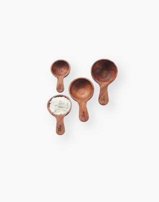 Four Measuring Cups crafted from solid acacia wood with gently rounded edges.