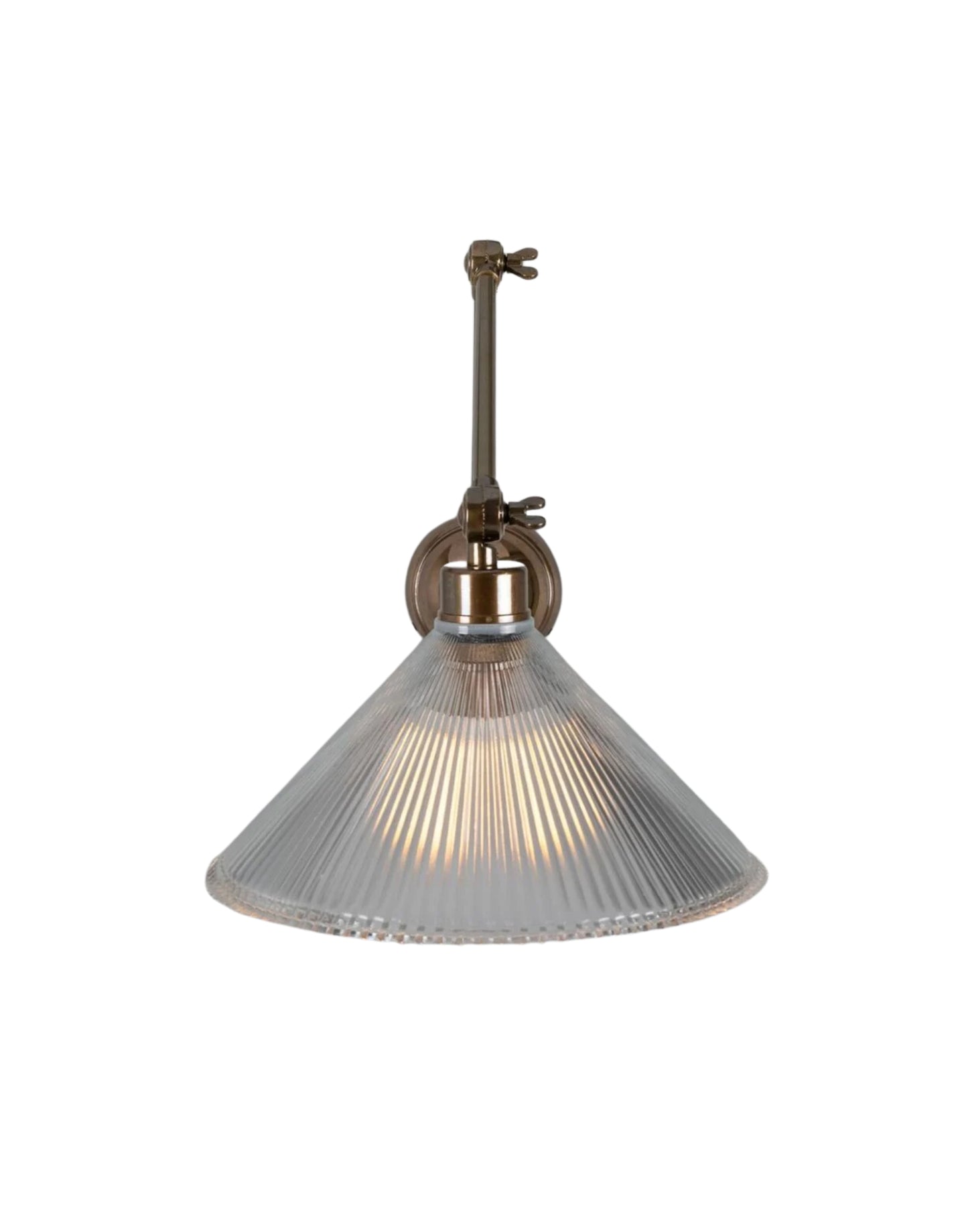 Adjustable brass wall sconce with articulated arm and ribbed prismatic glass shade for focused task lighting.