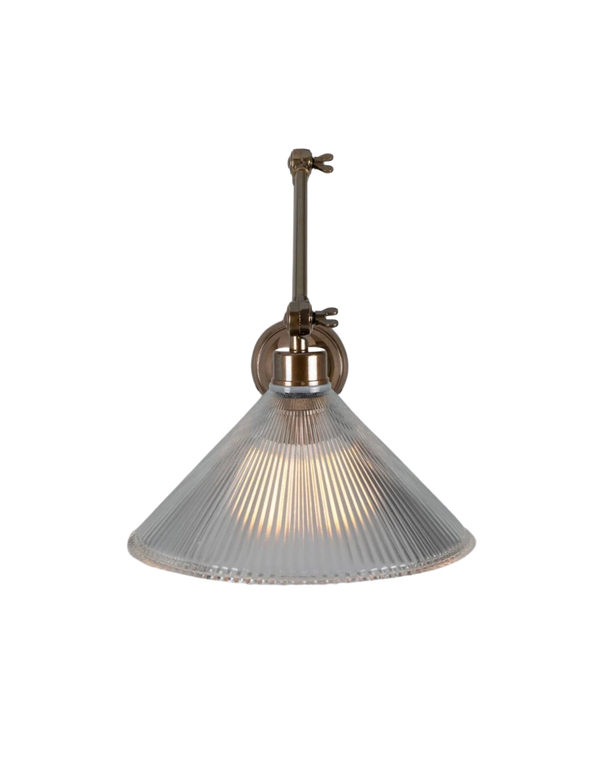 Adjustable brass wall sconce with articulated arm and ribbed prismatic glass shade for focused task lighting.