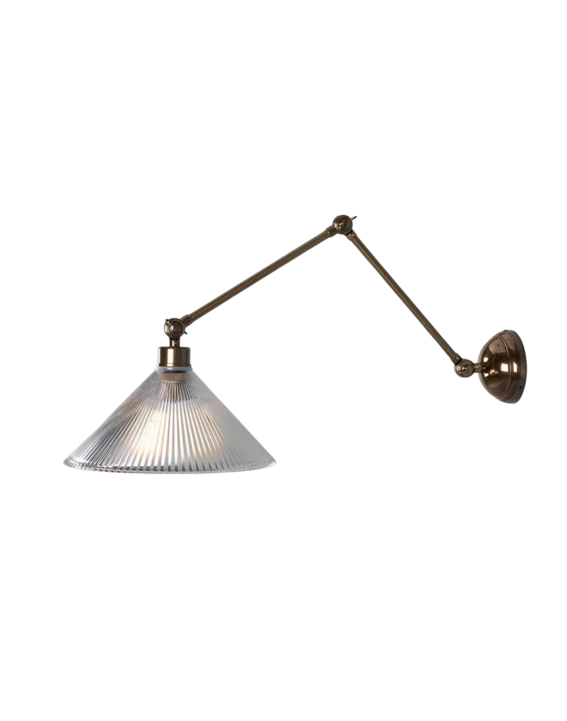 Adjustable brass wall sconce with articulated arm and ribbed prismatic glass shade for focused task lighting.
