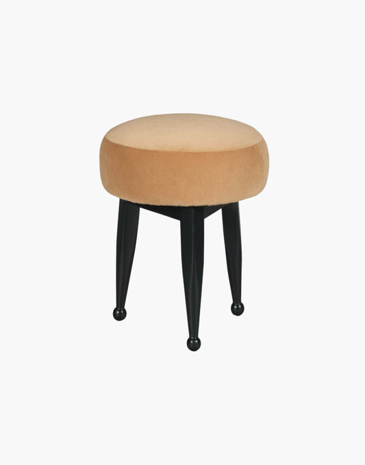 Ottoman with circular mushroom-shaped upholstered seat, three tapering legs with ball-shaped turnings, crafted from hardwood solids, available in Amsterdam Black or Banks Caramel Velvet.