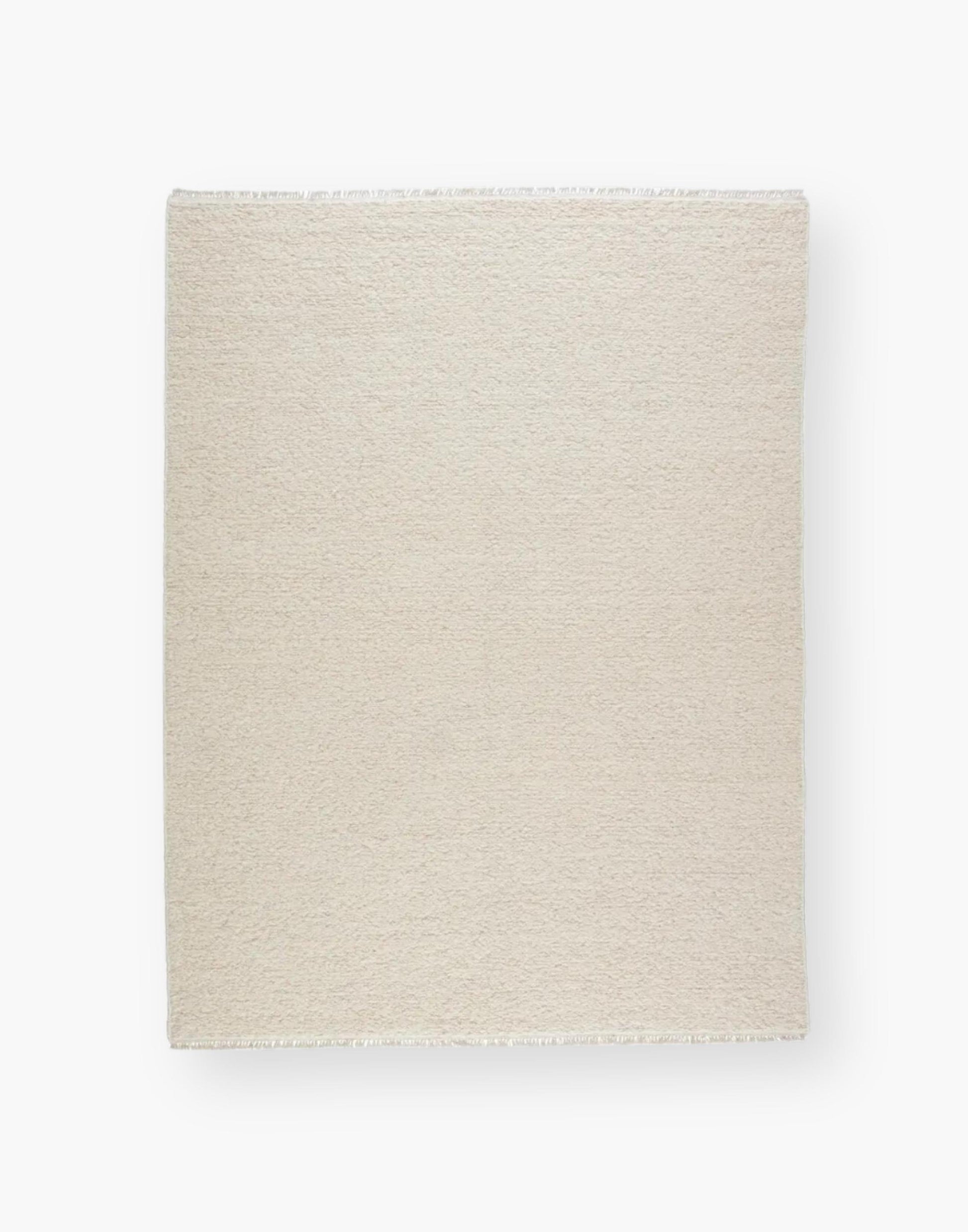 Wool rug with a light neutral cream palette and soft, textural soumak weave details.