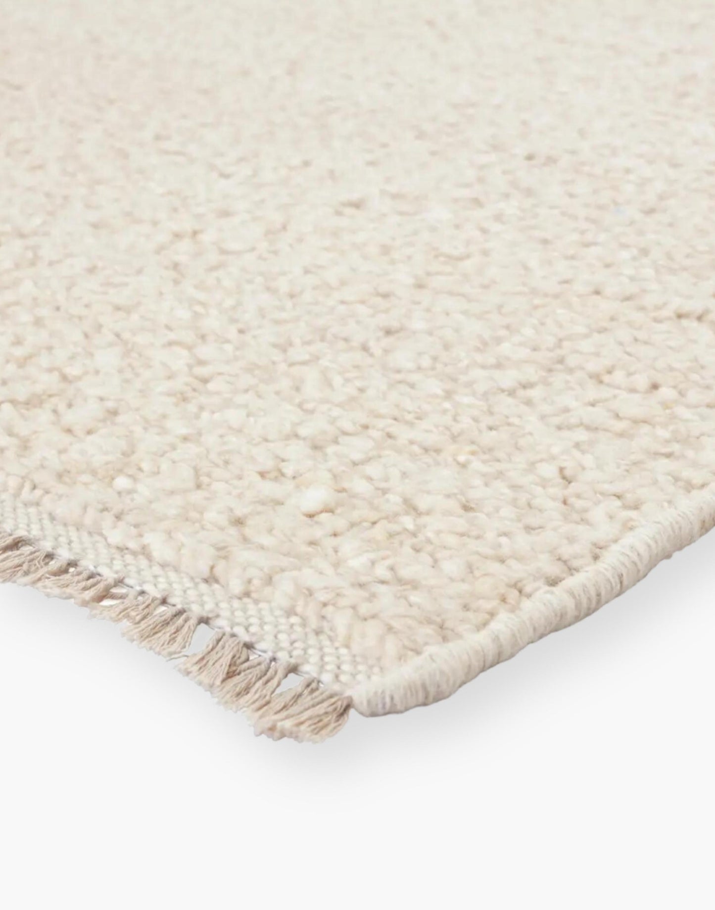 Wool rug with a light neutral cream palette and soft, textural soumak weave details.