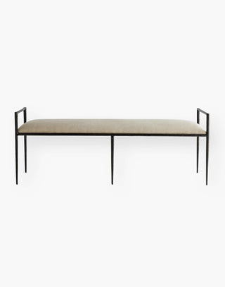 Iron body bench perched on a sharp angled frame with an upholstered seat in natural linen.