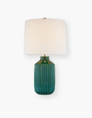 Table lamp with a subtle ribbed texture complemented by the dimensional, colorful glaze in emerald with a linen shade.