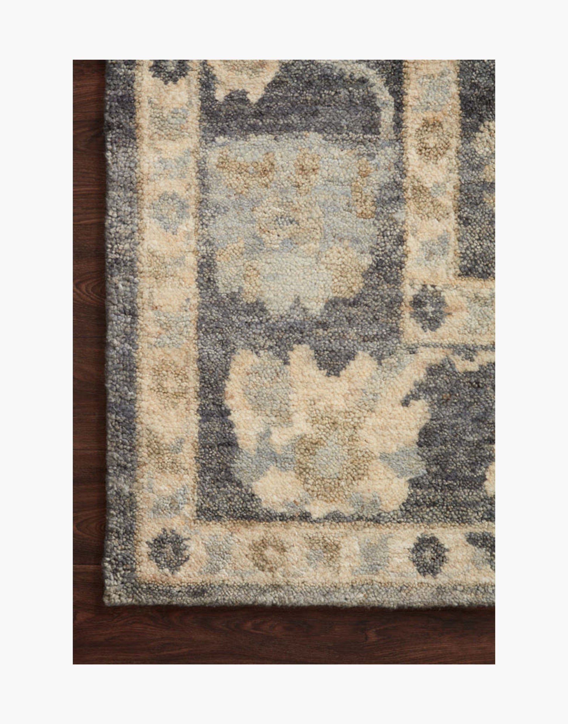 Hand-knotted wool rug in midnight and antique ivory tones
