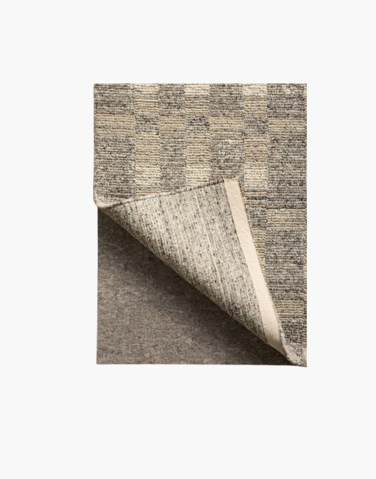Grey non-slip rug pad with rubber backing, 100% recycled fibers, fits rugs on hard floors and carpet