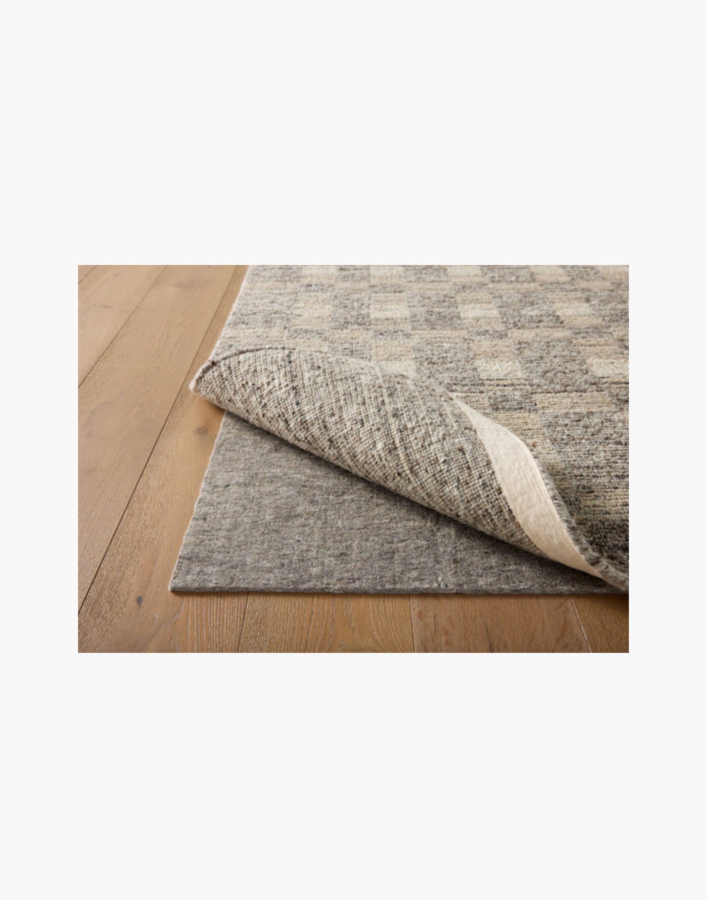Grey non-slip rug pad with rubber backing, 100% recycled fibers, fits rugs on hard floors and carpet