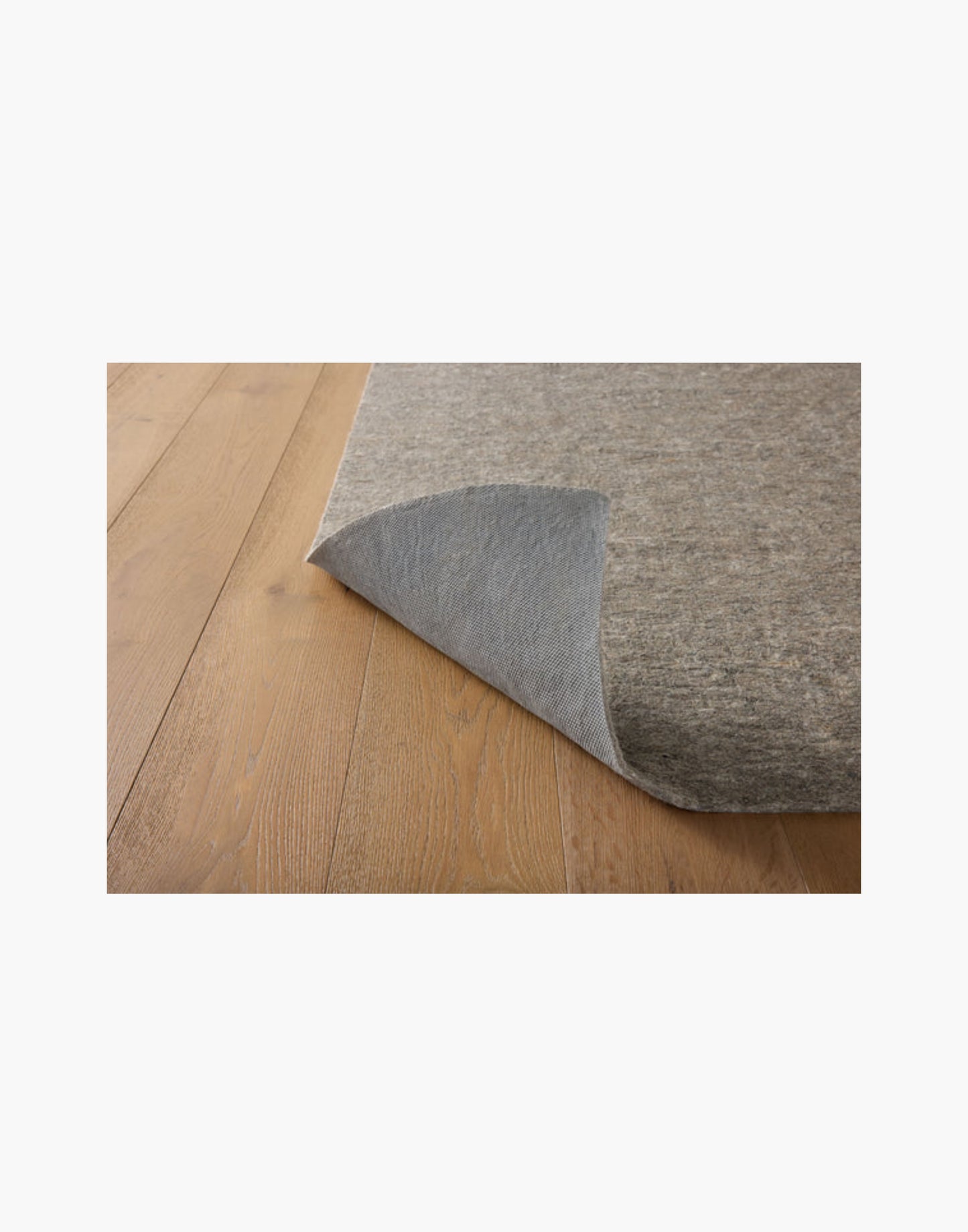 Grey non-slip rug pad with rubber backing, 100% recycled fibers, fits rugs on hard floors and carpet