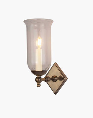 Christina Storm Glass Wall Sconce in solid brass with diamond-shaped backplate and scalloped edge. Rustic yet elegant, suits traditional and contemporary interiors.