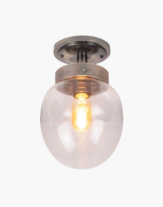 Charleston Flush Light in solid brass with mid-century design, available in five finishes with clear or opal glass. IP44-rated for Zone 2 bathrooms and covered outdoor areas.