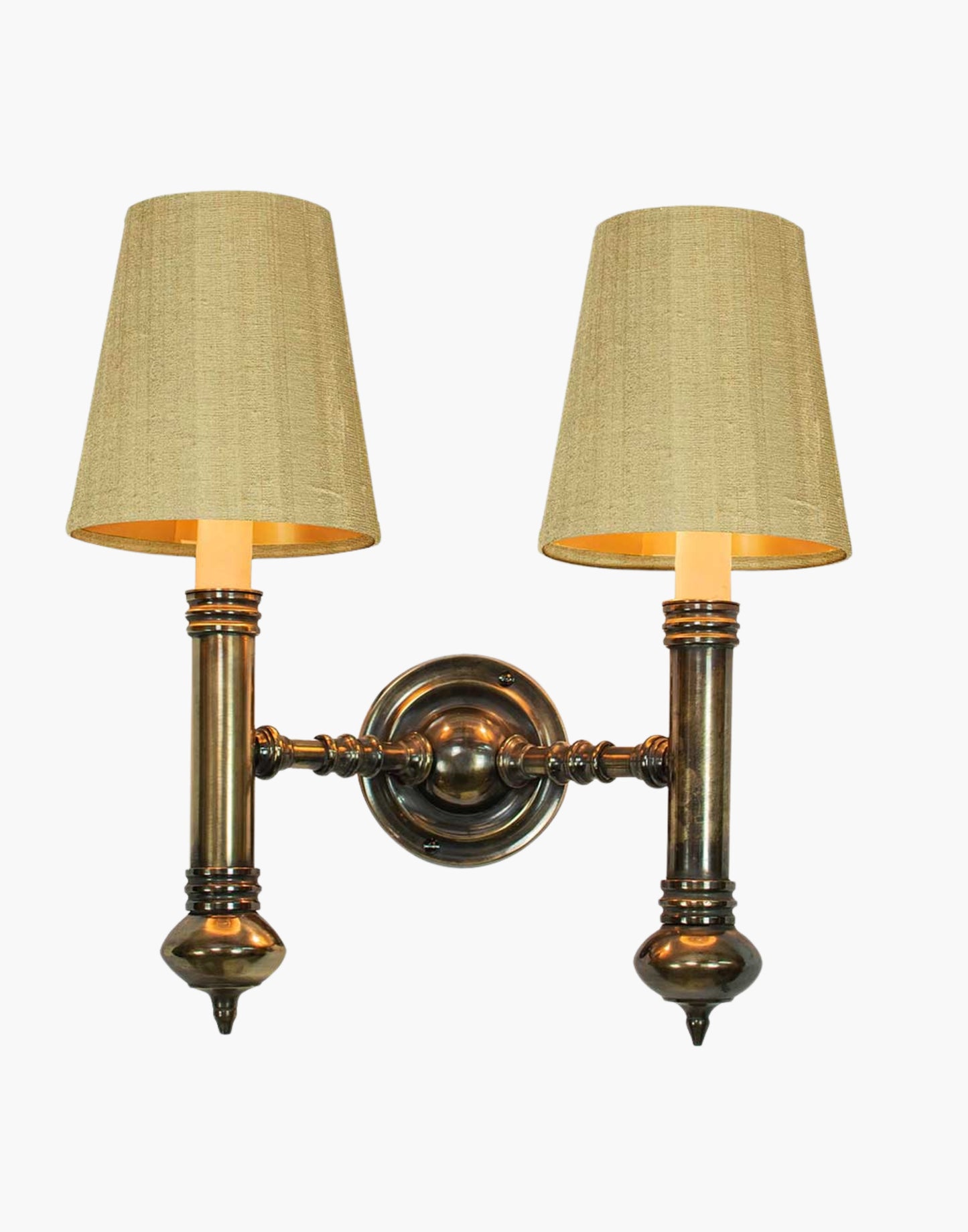 Twin Wall Sconce in cast brass, compact period-style double wall light creating warm ambient illumination.