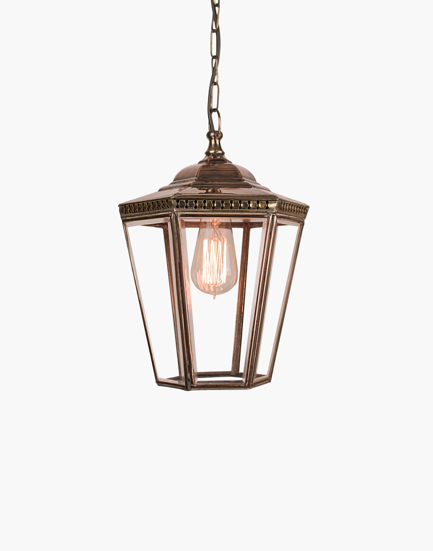 Pendant lantern in solid copper with pierced brass fretwork, beveled glass, finial and chain, suitable for damp locations.