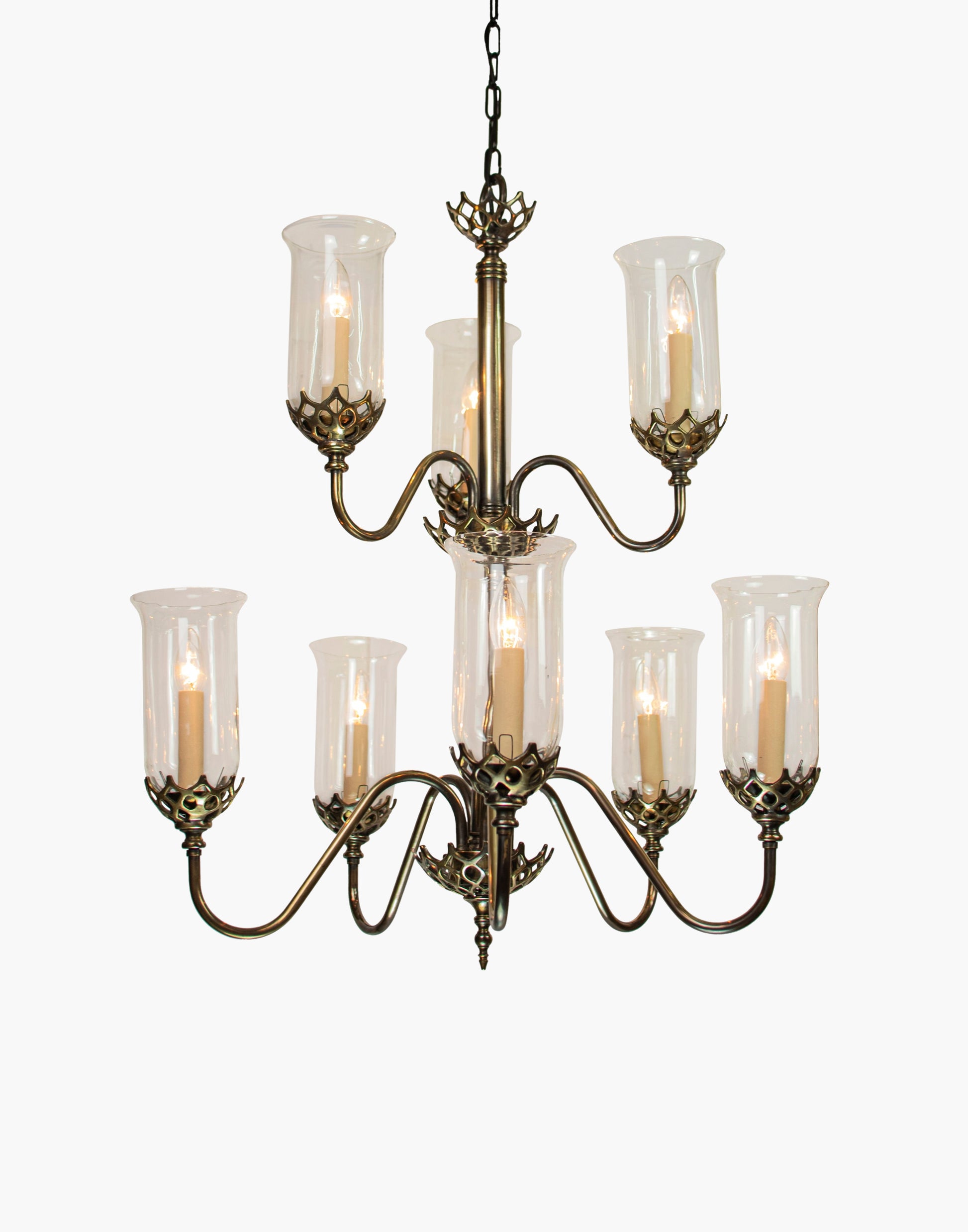 Eight arm chandelier in cast brass with clear storm glasses, statement period ceiling light inspired by an 1800 Irish church original.