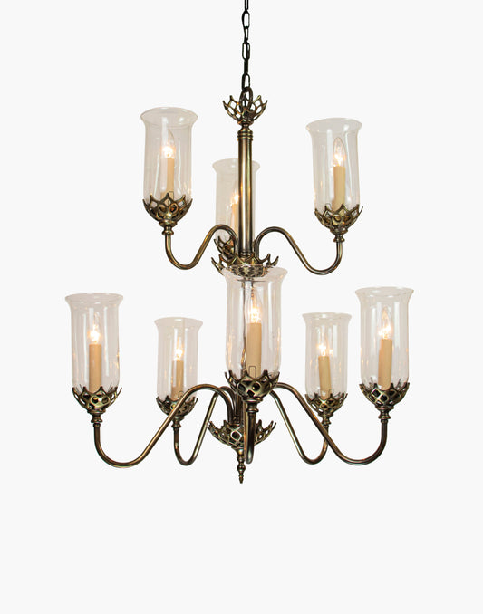 Eight arm chandelier in cast brass with clear storm glasses, statement period ceiling light inspired by an 1800 Irish church original.