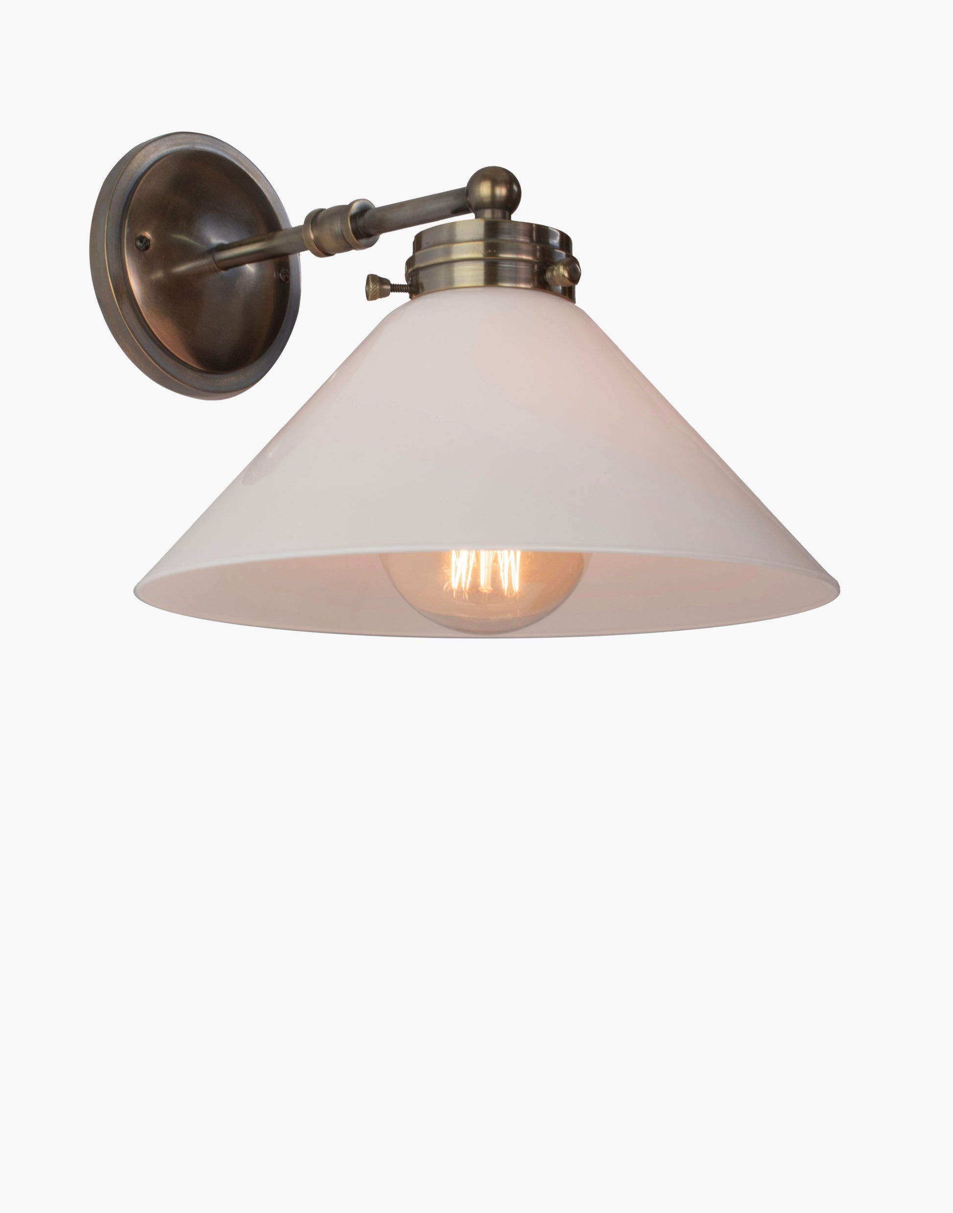 Wall light with solid brass construction, available with glass or brass shade, adjustable ambient or focused lighting for Victorian-inspired or contemporary interiors.