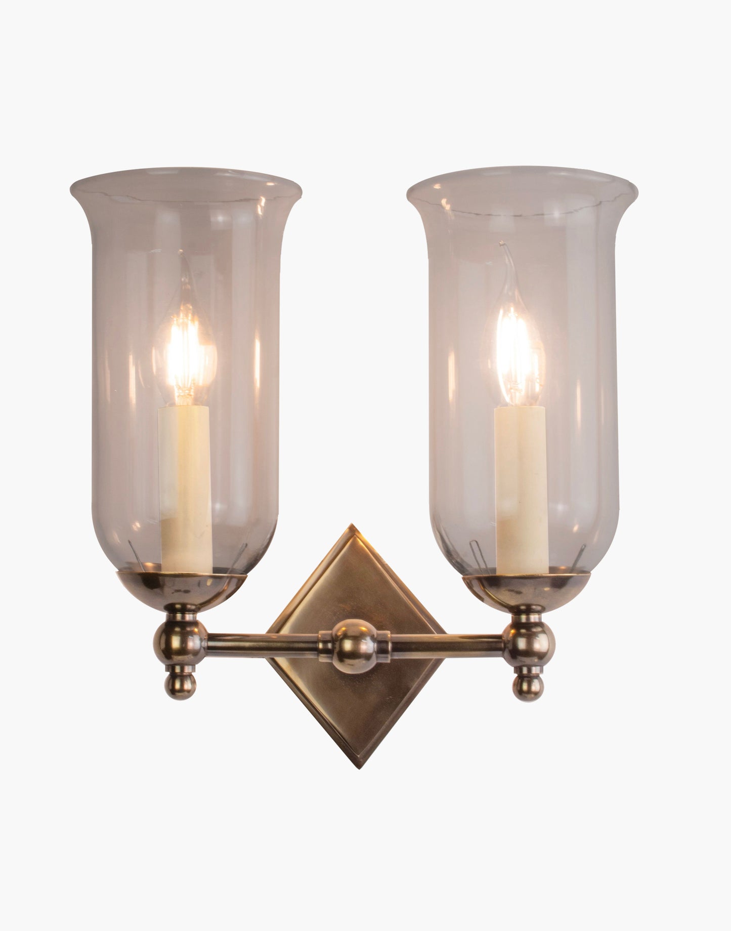 Storm Glass wall sconce twin in brass with diamond back plate, scalloped edge, and rustic storm glass shades for bathroom or interior lighting