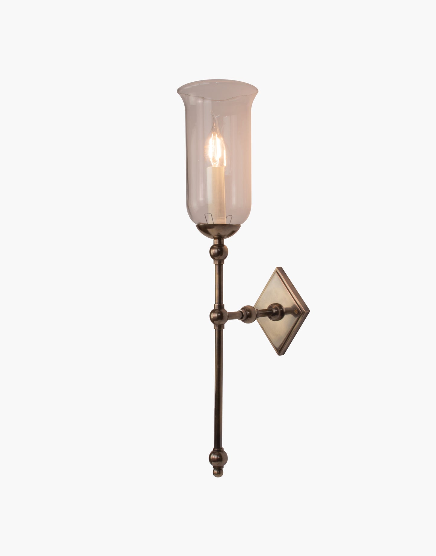 Tall Storm Glass brass wall sconce with elongated profile and rustic glass shade, ideal for bathroom or interior lighting