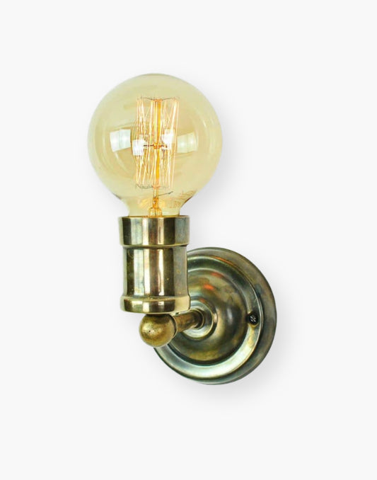 Fixed wall light in solid brass with exposed squirrel cage bulb, industrial World War One inspired wall sconce in antique brass or polished nickel.