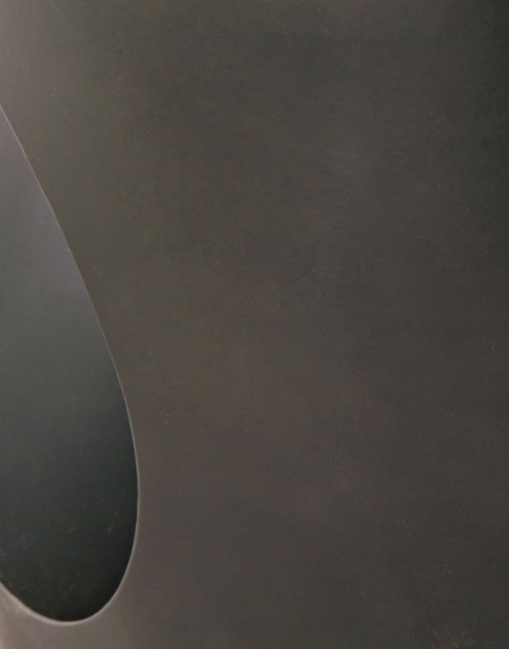 Modern matte black oval steel coffee table.