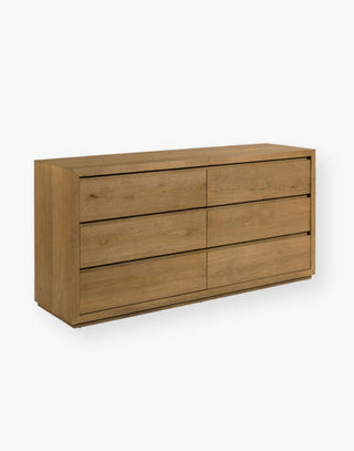 Oak and Veneer Chest with minimalist geometric form, six individual drawers molded to have finger grooves for opening, and is elevated on a recessed plinth base.