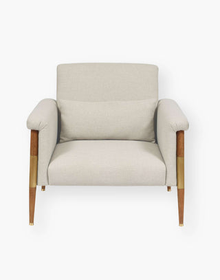 Chair with brass elbows on a wood frame with textured, natural-hued performance fabric.