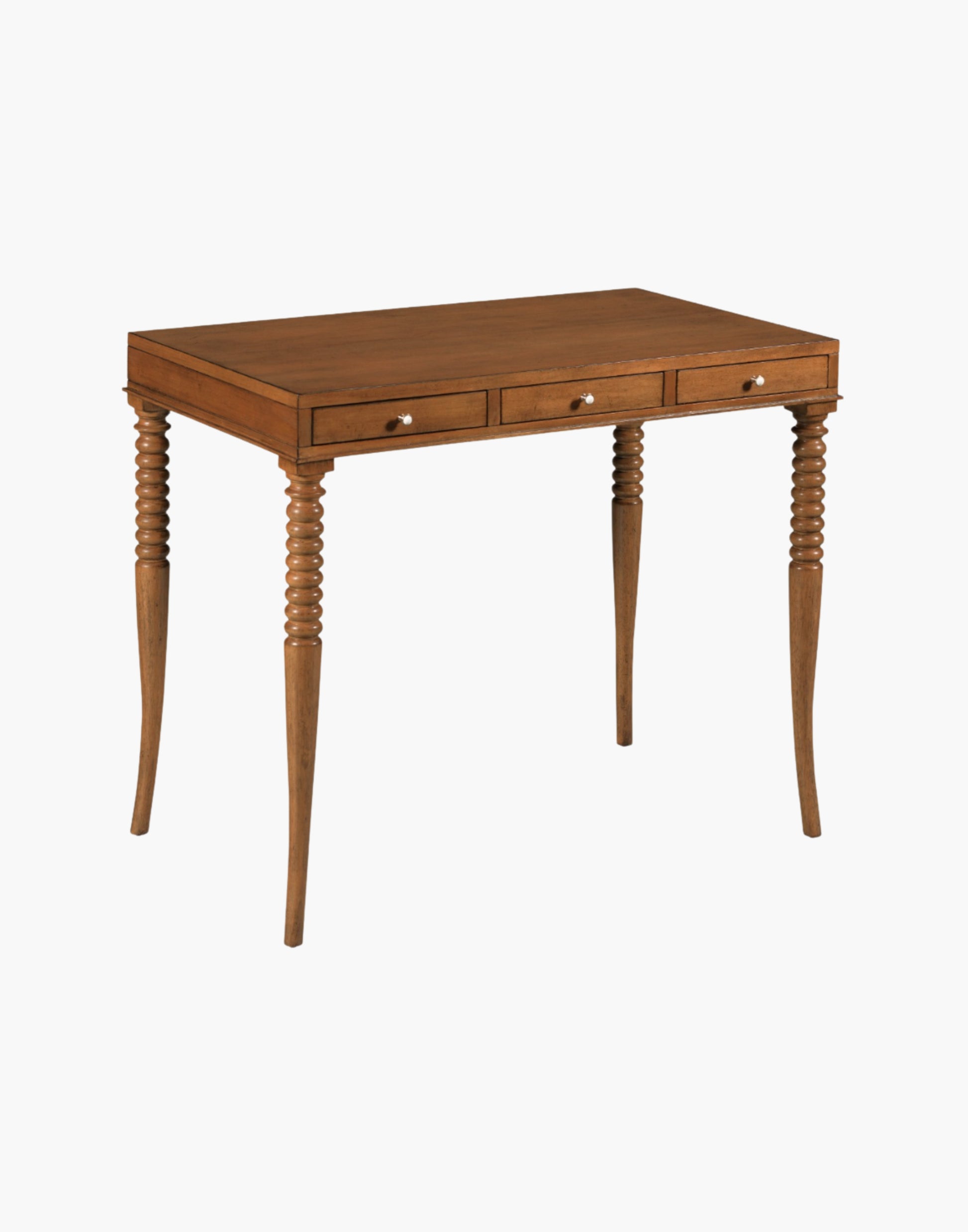 Writing Table Desk in Praline finish with rectangular top, turned flared legs, and three soft-close drawers with brass hardware.