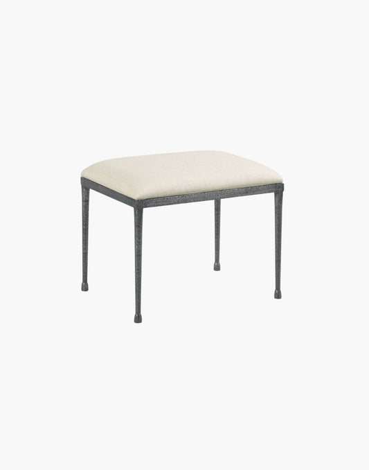 hammered metal footstool with textured steel base and linen upholstered seat