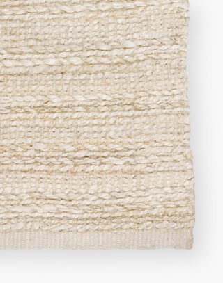 Jute area rug with cotton backing and a rayon blend with creamy natural and bleached white colorway.