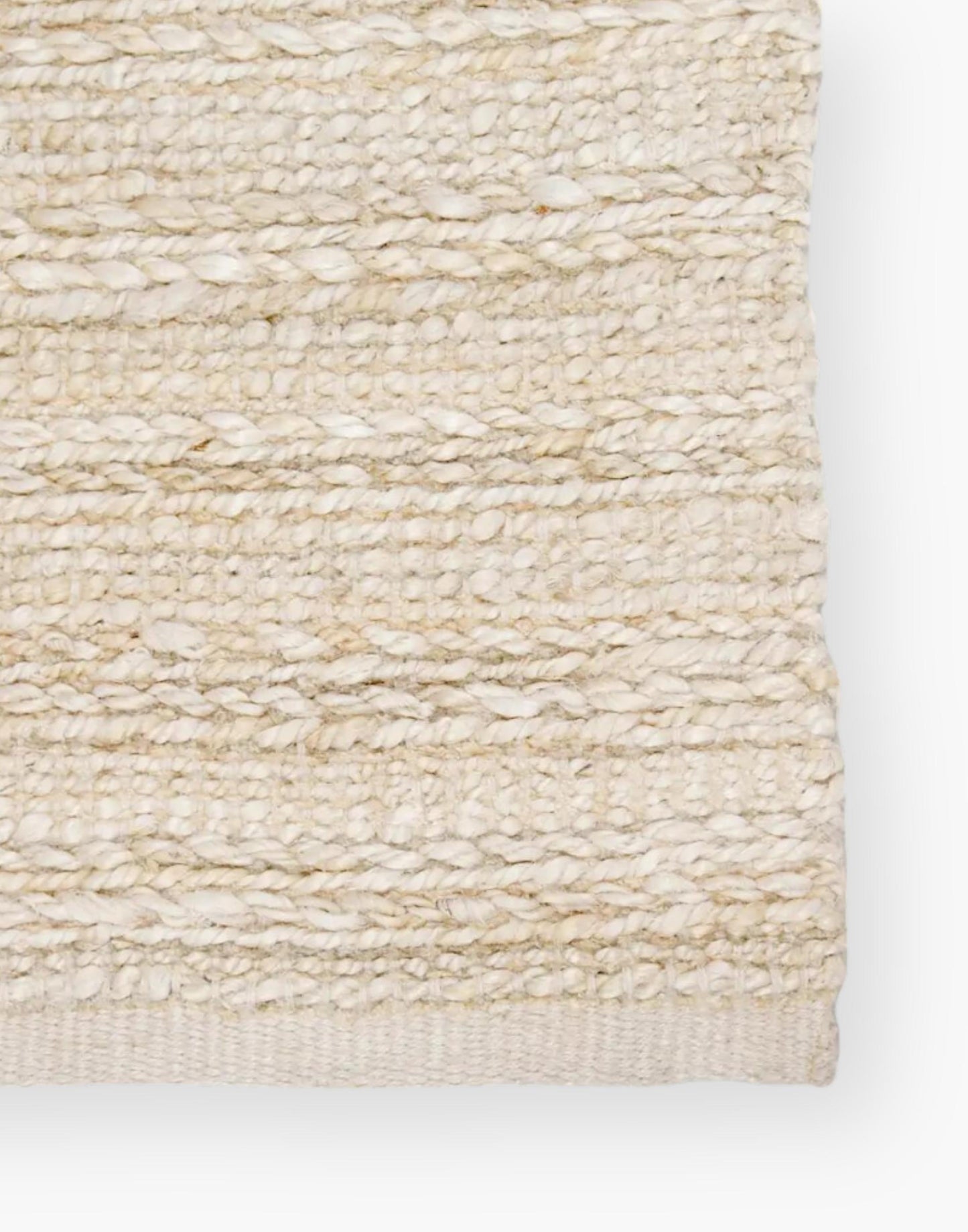 Jute area rug with cotton backing and a rayon blend with creamy natural and bleached white colorway.
