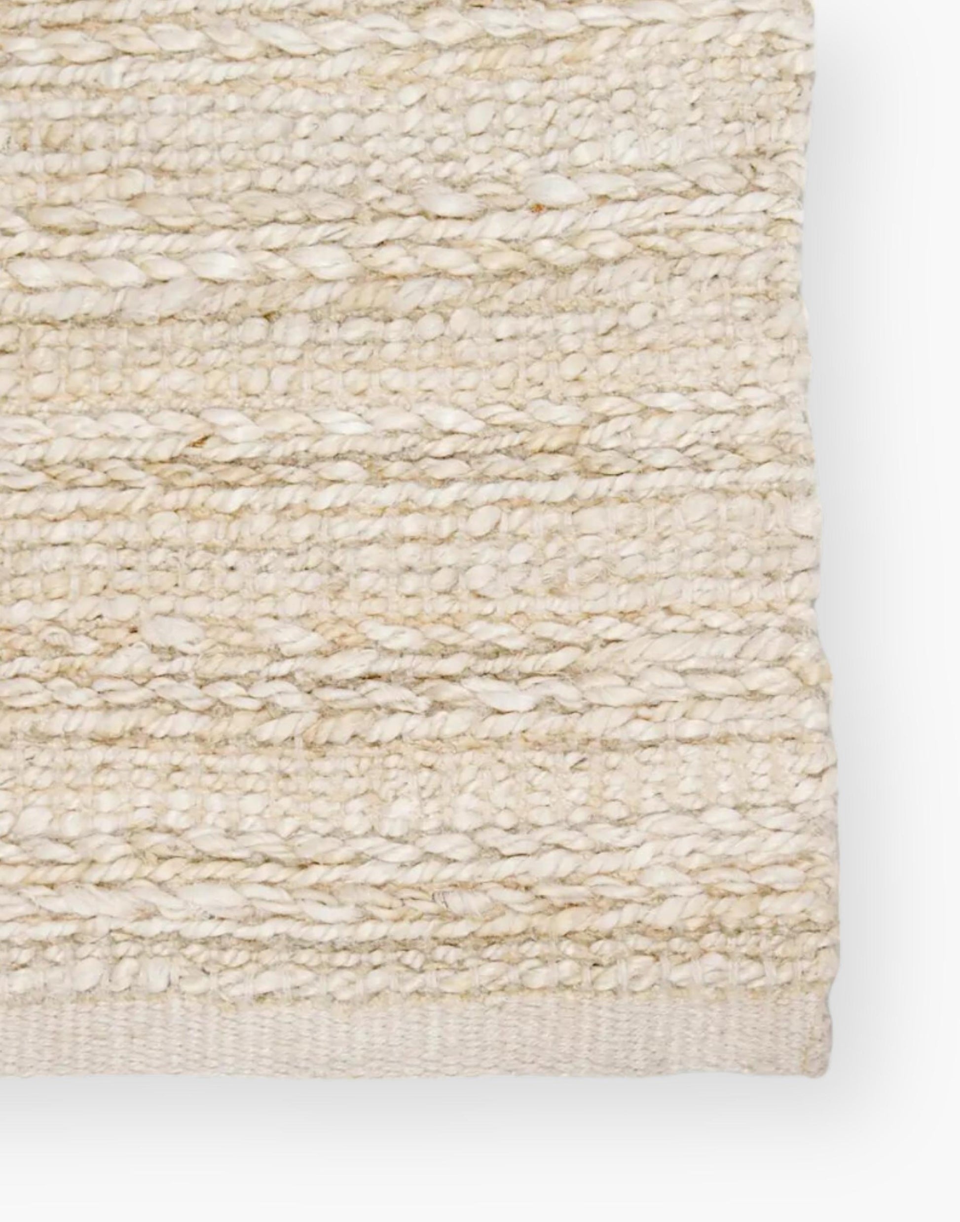 Jute area rug with cotton backing and a rayon blend with creamy natural and bleached white colorway.