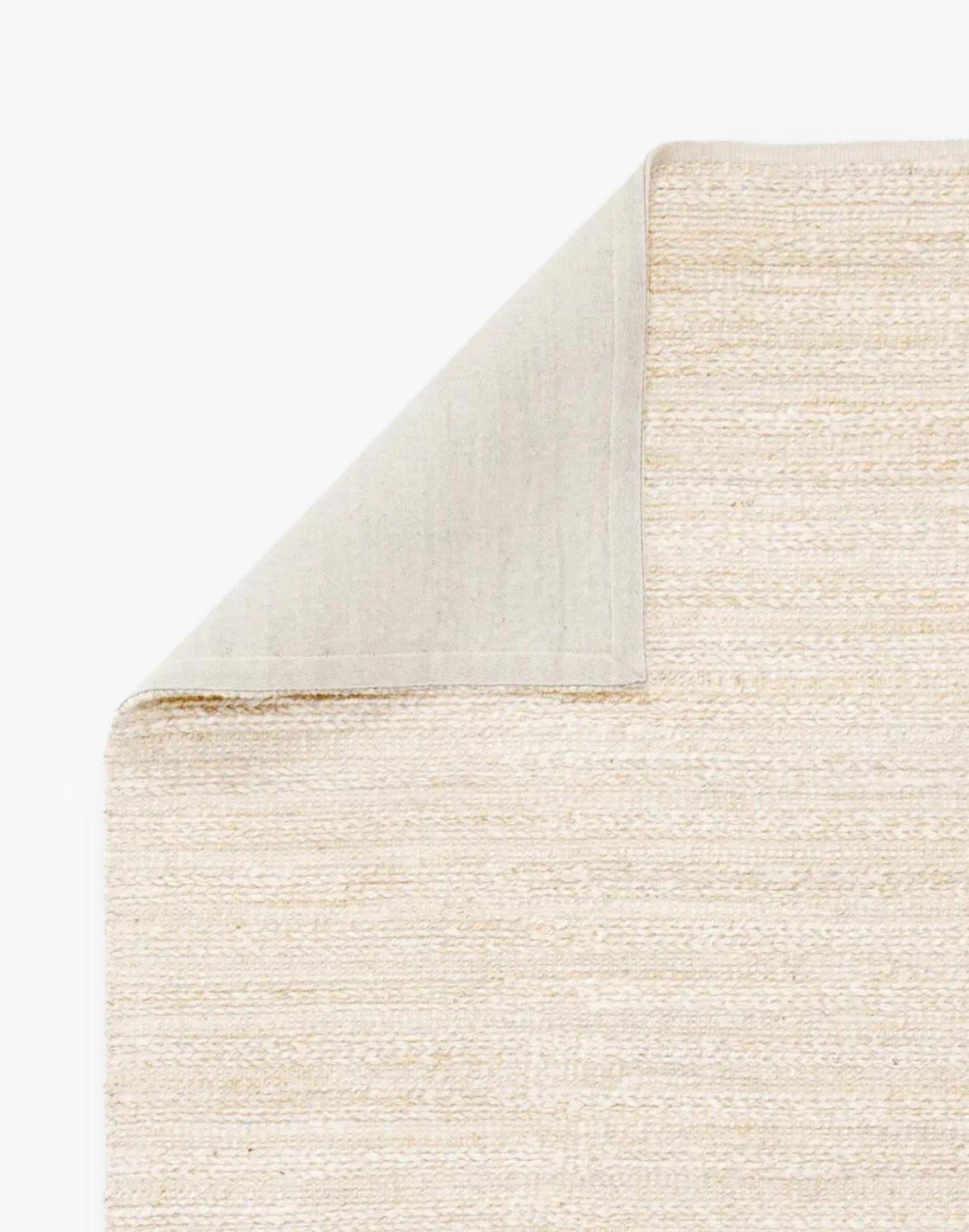 Jute area rug with cotton backing and a rayon blend with creamy natural and bleached white colorway.