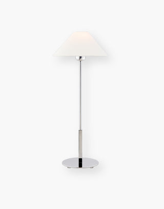 Modern floor lamp in polished nickel with a linen shade.