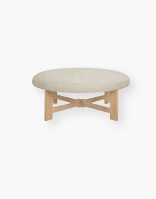 ottoman with wood legs and a linen/woven fabric top