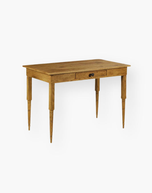 A rectangular top rests on multi-ringed turned corner posts that flank an apron rail drawer.