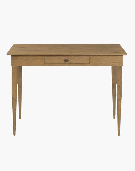A rectangular top rests on multi-ringed turned corner posts that flank an apron rail drawer.