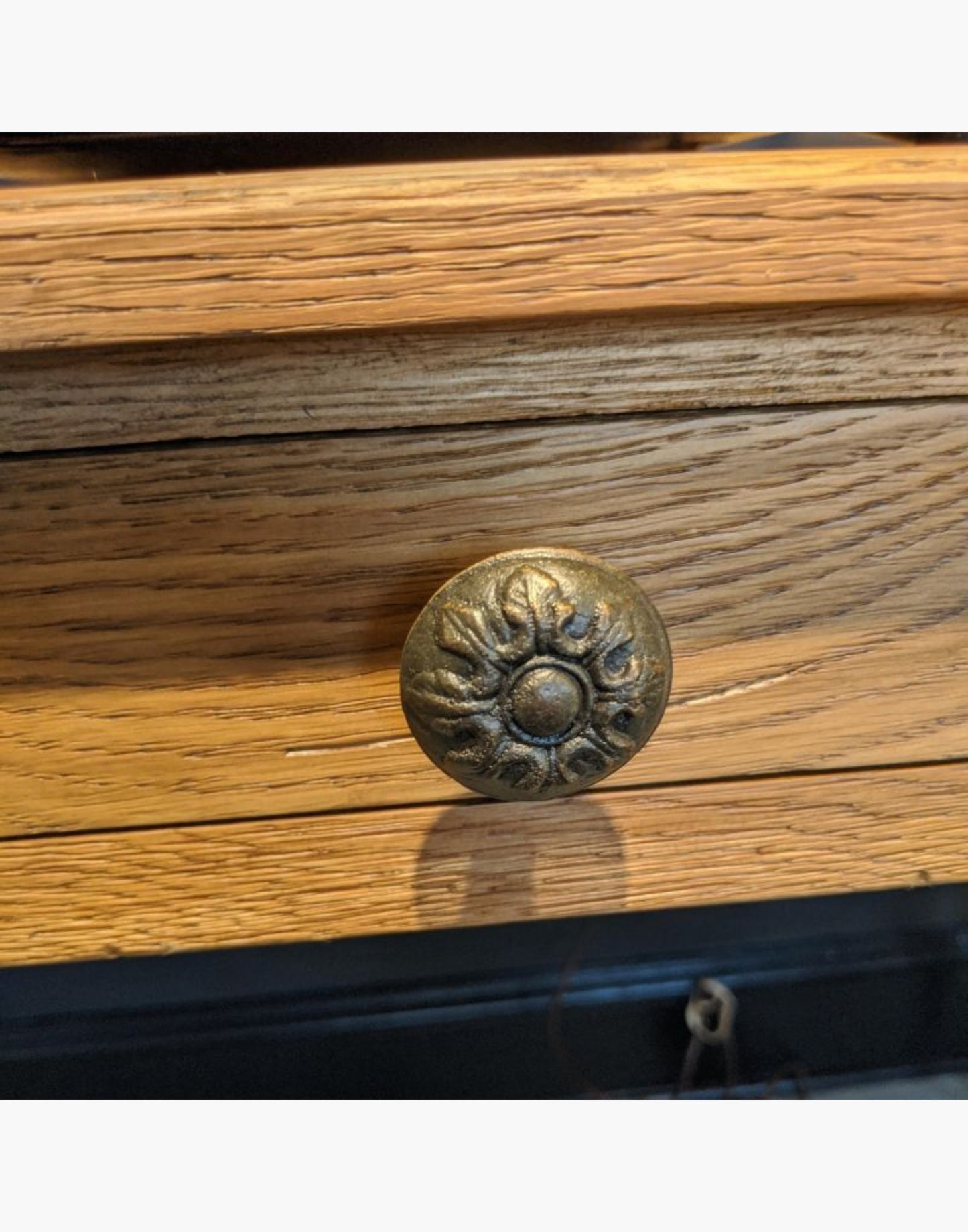 A rectangular top rests on multi-ringed turned corner posts that flank an apron rail drawer.