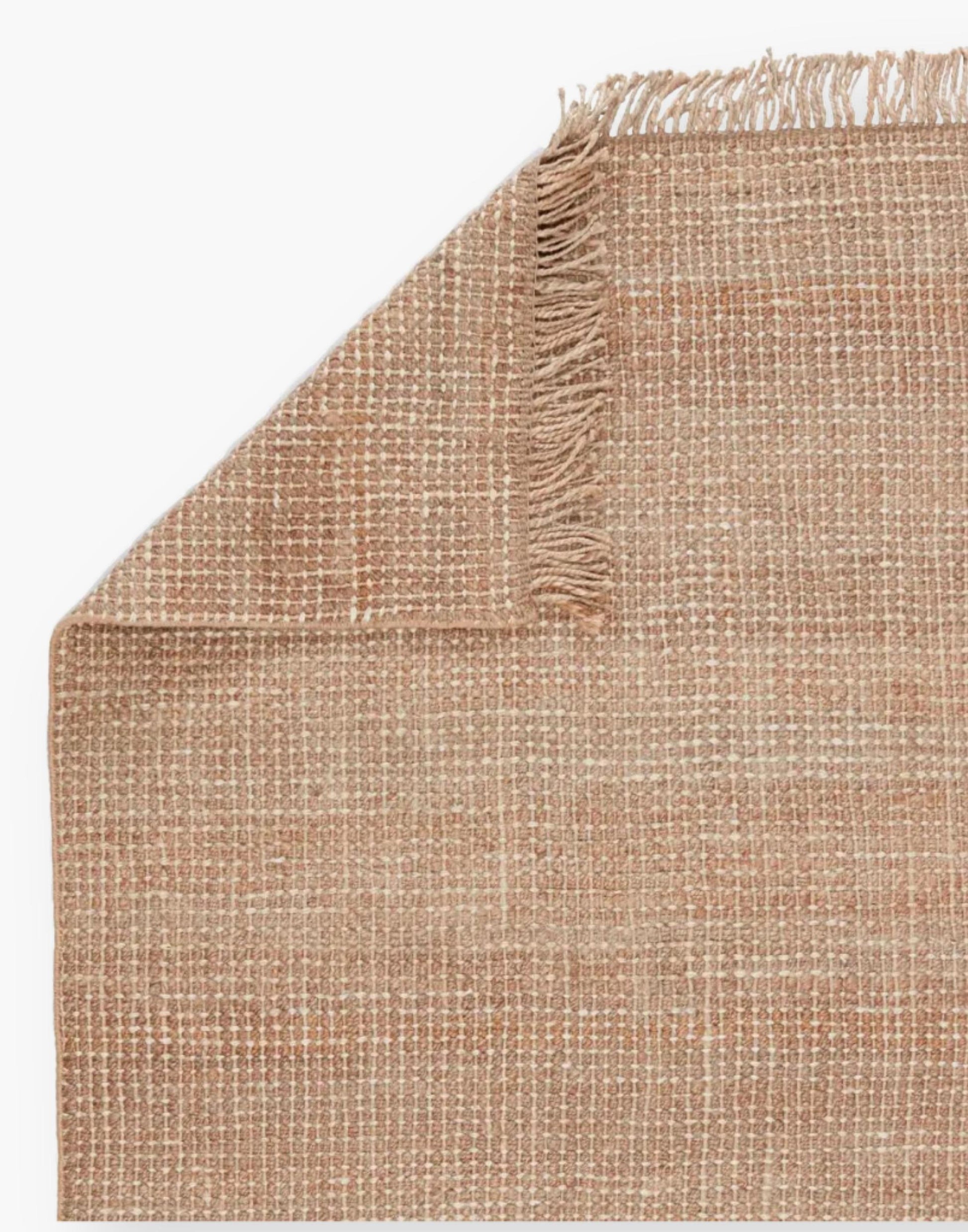 Jute rug with a texture-rich chunky weave, with a casually elegant layer lends an earthy accent in a duo-toned ivory and beige colorway with a knotted fringe.