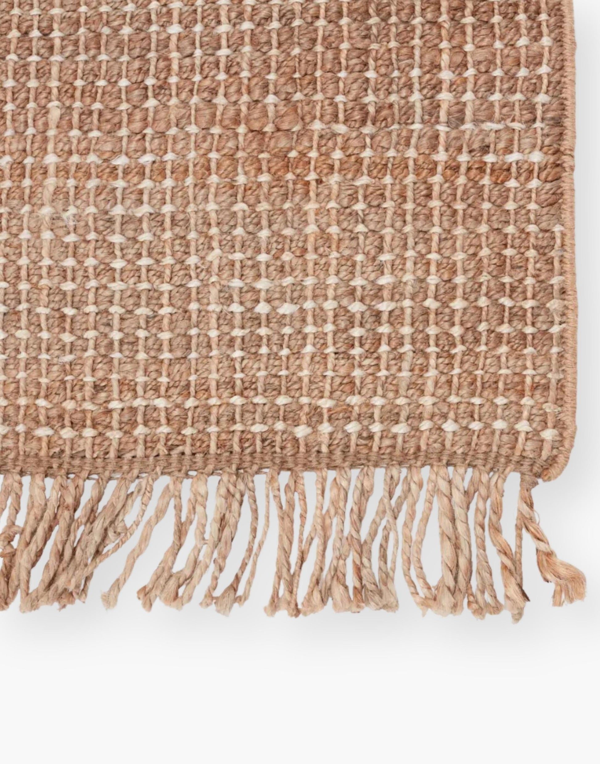 Jute rug with a texture-rich chunky weave, with a casually elegant layer lends an earthy accent in a duo-toned ivory and beige colorway with a knotted fringe.