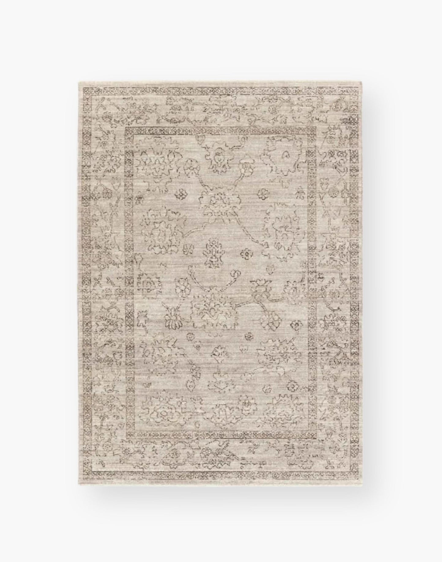 Polyester area rug that features a distressed, floral design in warm tones of brown, gray, taupe, and cream.