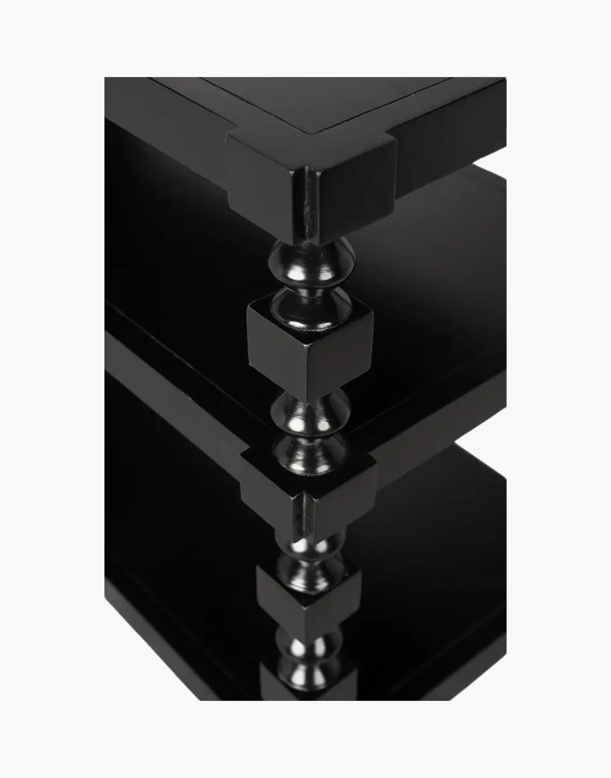 Transitional console table with black finish and open storage shelves in living room setting
