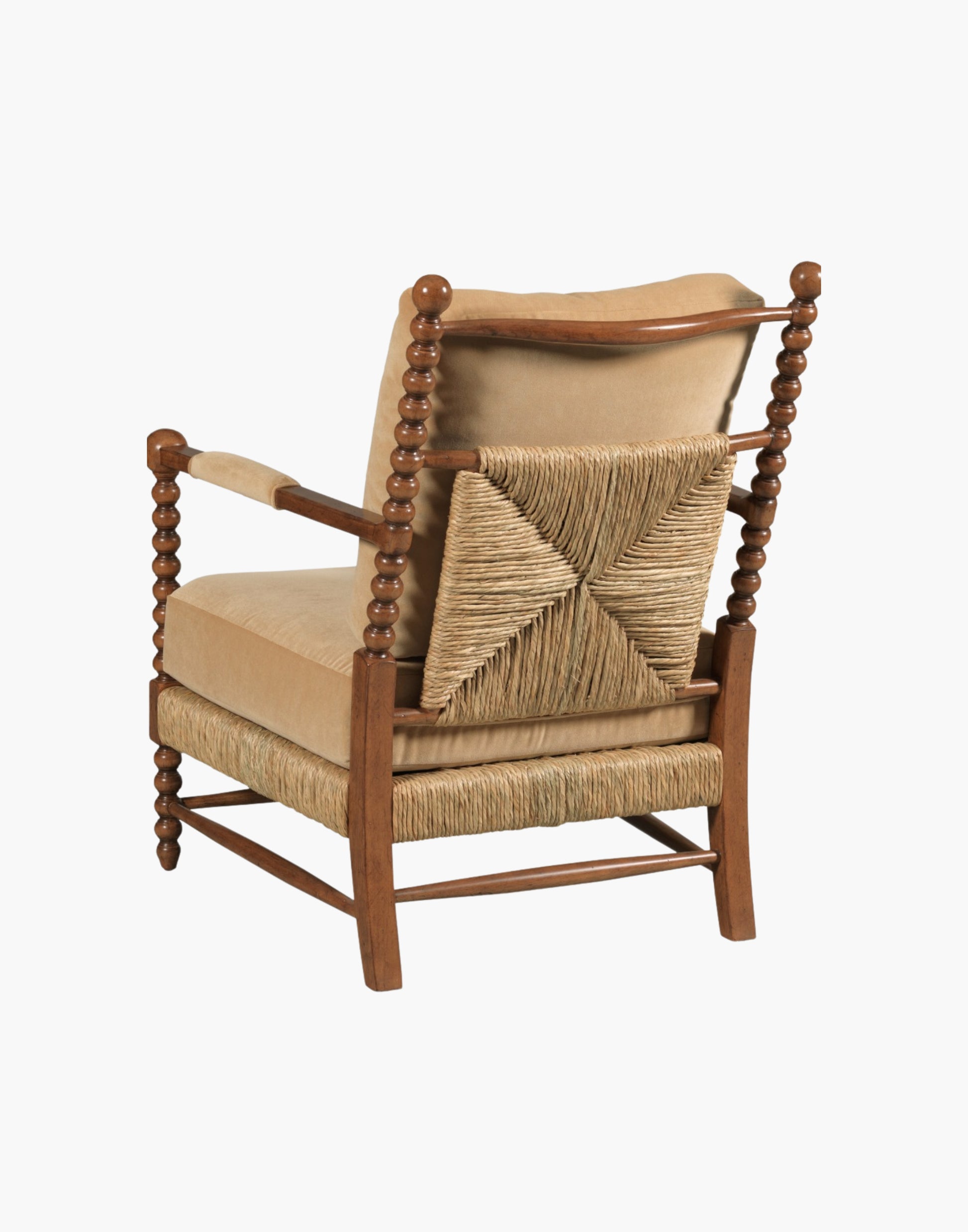 Lounge Chair with bobbin-turned posts, loose upholstered cushions over woven rush seat and back, paddle arms with padded upholstery, hardwood solids, finished in Praline with Banks Caramel Velvet upholstery.