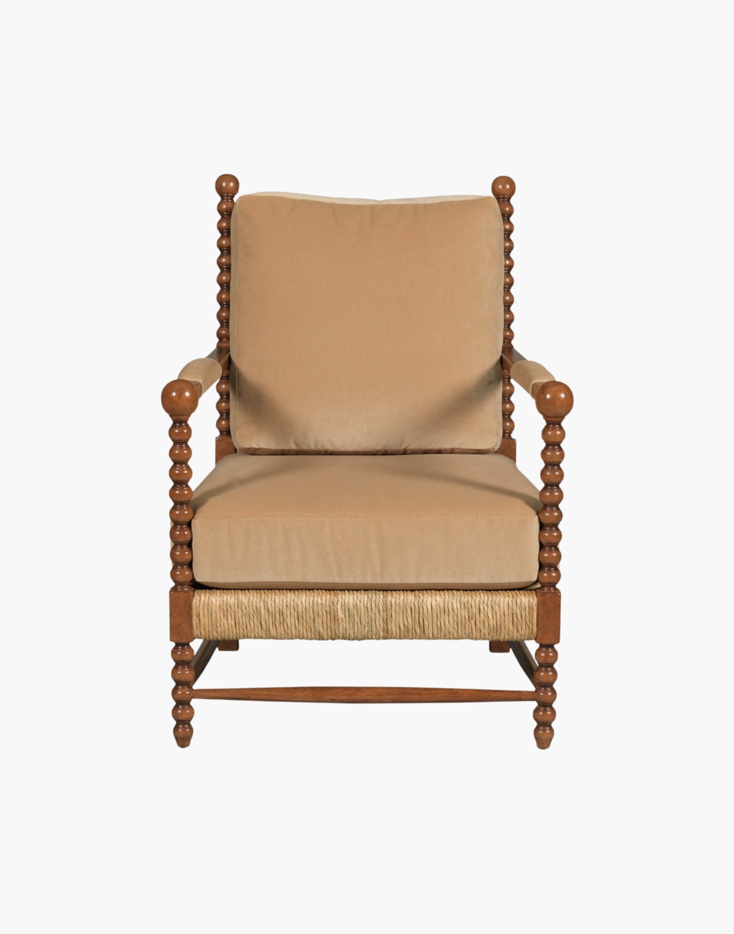 Lounge Chair with bobbin-turned posts, loose upholstered cushions over woven rush seat and back, paddle arms with padded upholstery, hardwood solids, finished in Praline with Banks Caramel Velvet upholstery.
